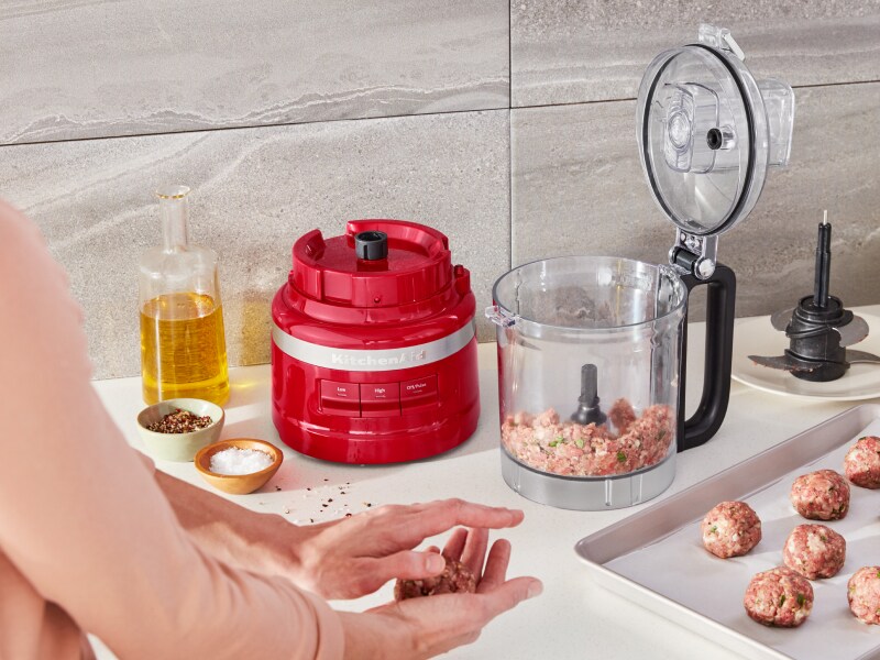 Ground beef inside a red KitchenAid® food processor Ground beef inside a red KitchenAid® food processor