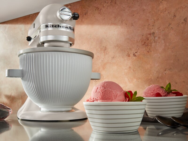 KitchenAid® stand mixer on countertop with two bowls of ice cream KitchenAid® stand mixer on countertop with two bowls of ice cream