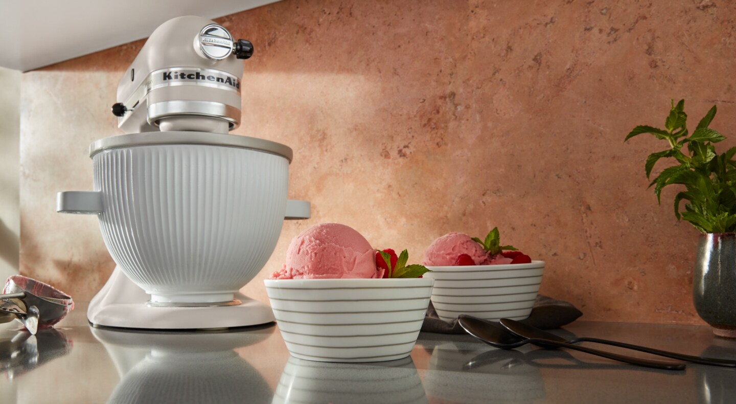 KitchenAid® stand mixer on countertop with two bowls of ice cream KitchenAid® stand mixer on countertop with two bowls of ice cream