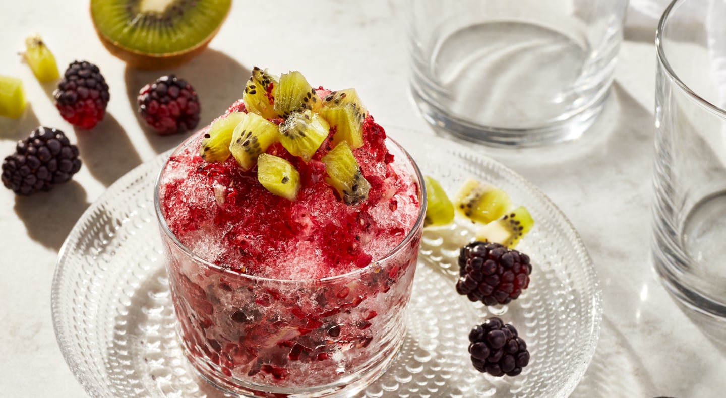 Shaved ice dessert topped with chopped fruit Shaved ice dessert topped with chopped fruit