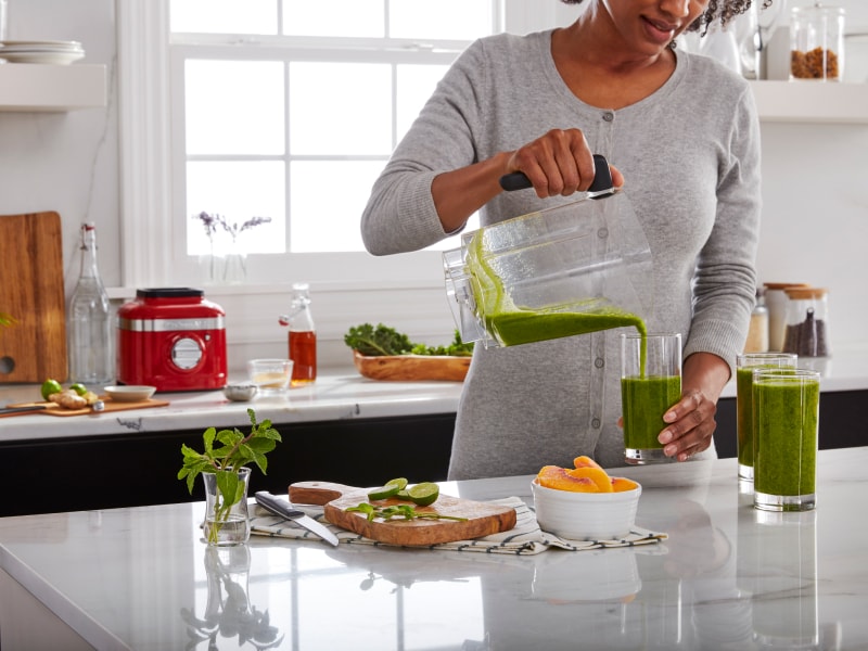 Person pouring a shake into a glass Person pouring a shake into a glass