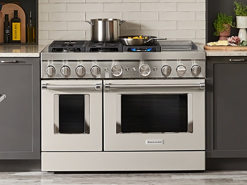 Dishes cooking on a large drop-in oven