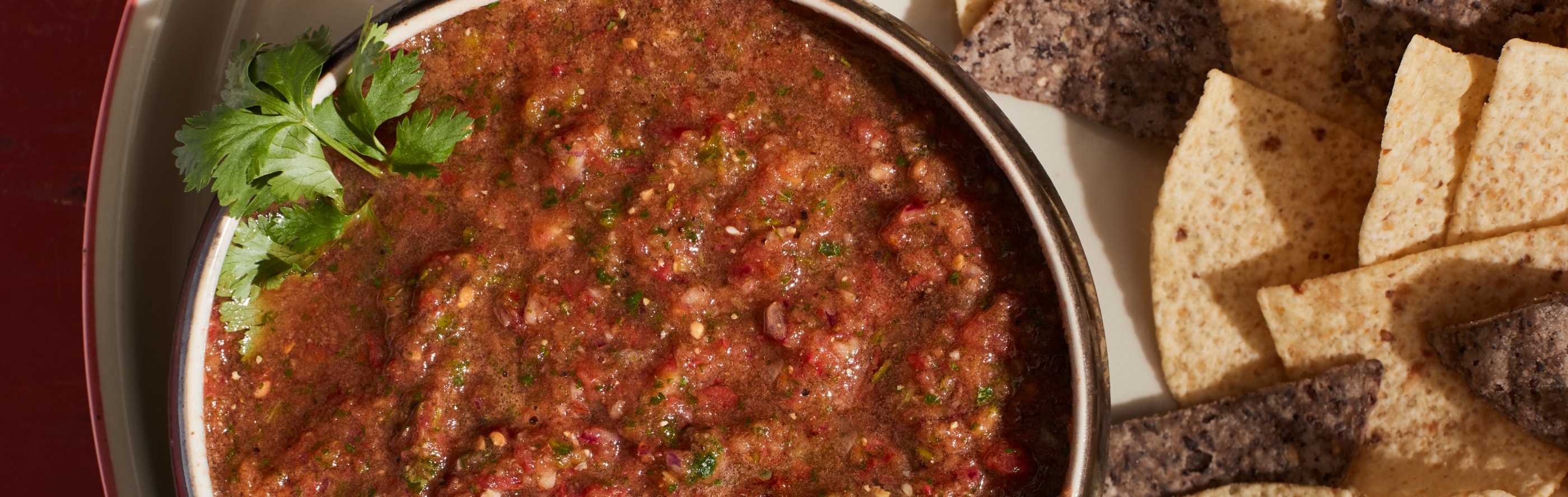 A bowl of blender salsa and chips