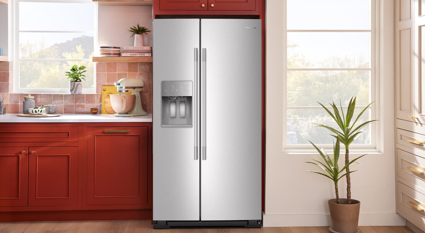 A bright kitchen with a stainless steel refrigerator