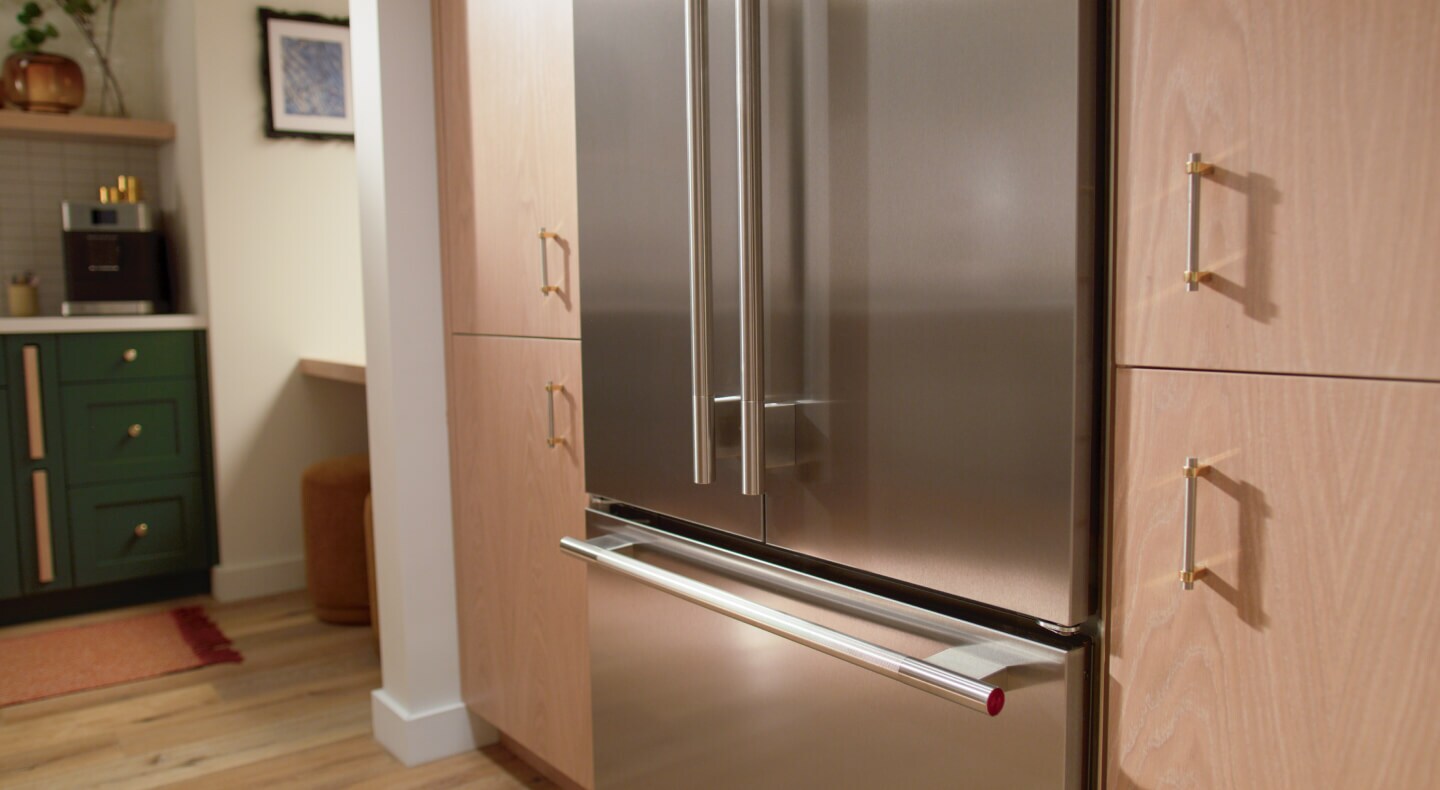 A French-door refrigerator surrounded by cabinetry