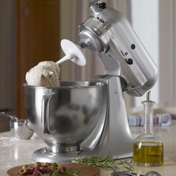 Silver KitchenAid® tilt-head stand mixer with dough on the dough hook