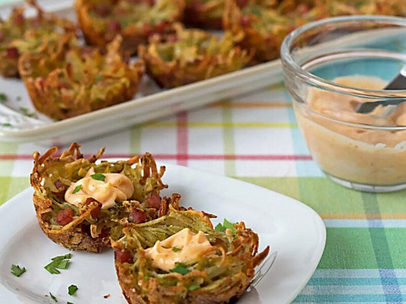 A plate of potato vegetable fritters with an aioli sauce  A plate of potato vegetable fritters with an aioli sauce