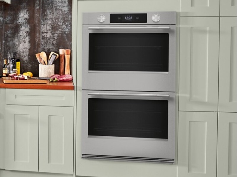 A double wall oven surrounded by cabinetry