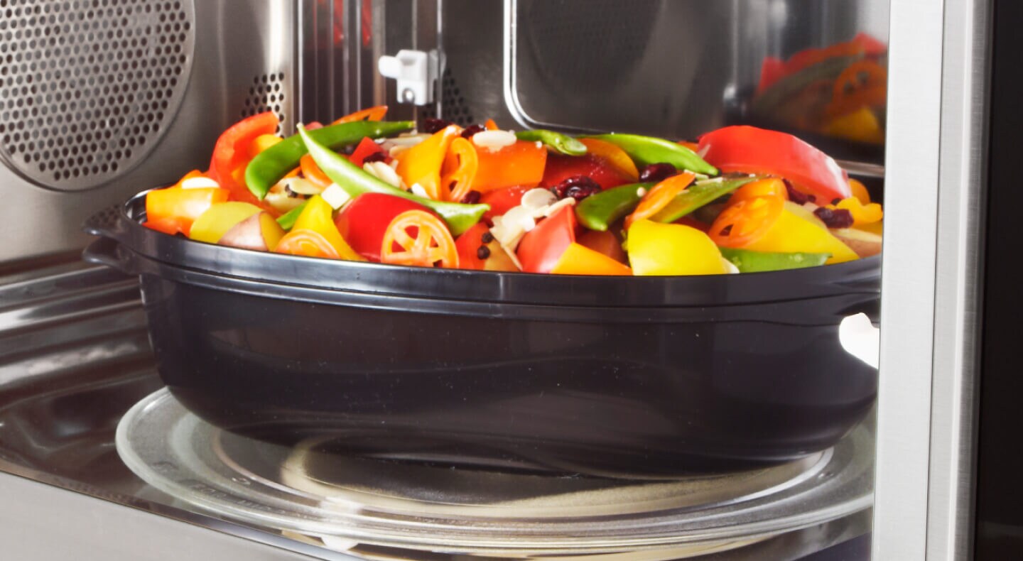 Vegetables in a container in a microwave