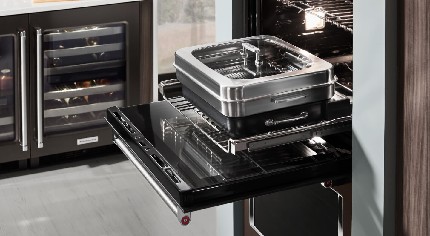 An oven with cookware used for steaming