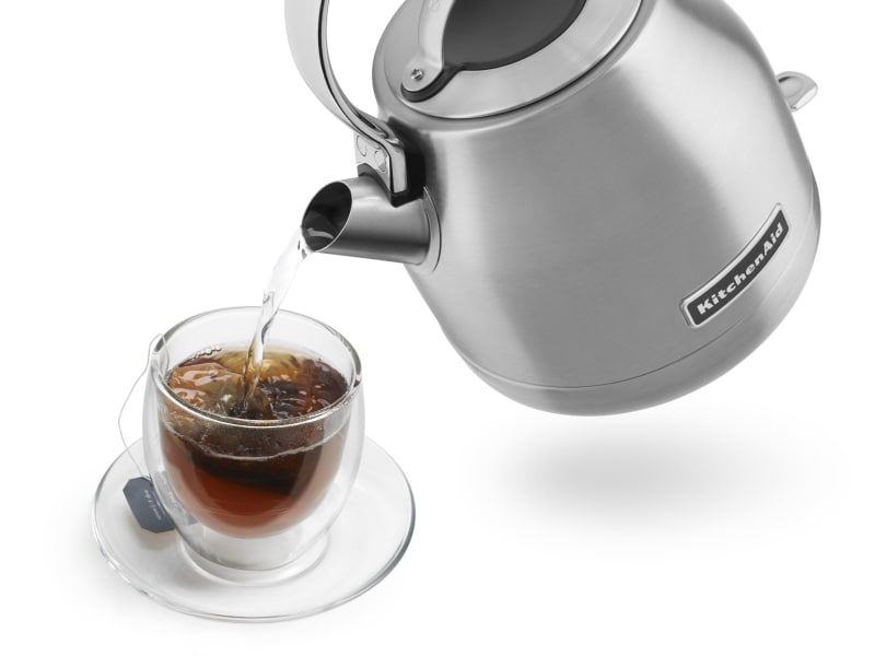 Hot water being poured from KitchenAid® kettle into glass of tea Hot water being poured from KitchenAid® kettle into glass of tea