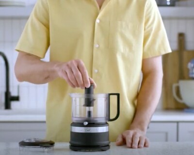 Person assembling black food chopper