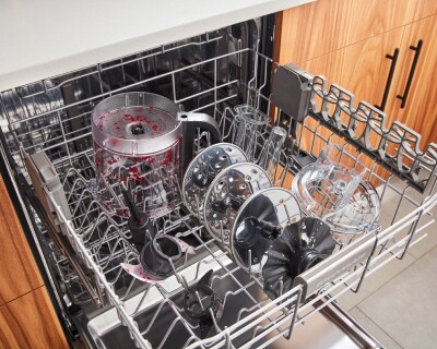 Dirty food chopper parts in top dishwasher rack