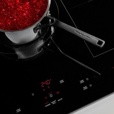 An induction cooktop set at 240 degrees with a pan on it An induction cooktop set at 240 degrees with a pan on it