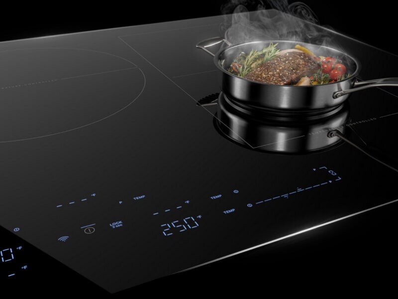 An induction cooktop with steak in a pan on it