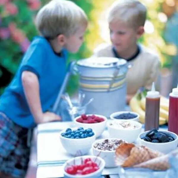 Two children at an ice cream sundae bar