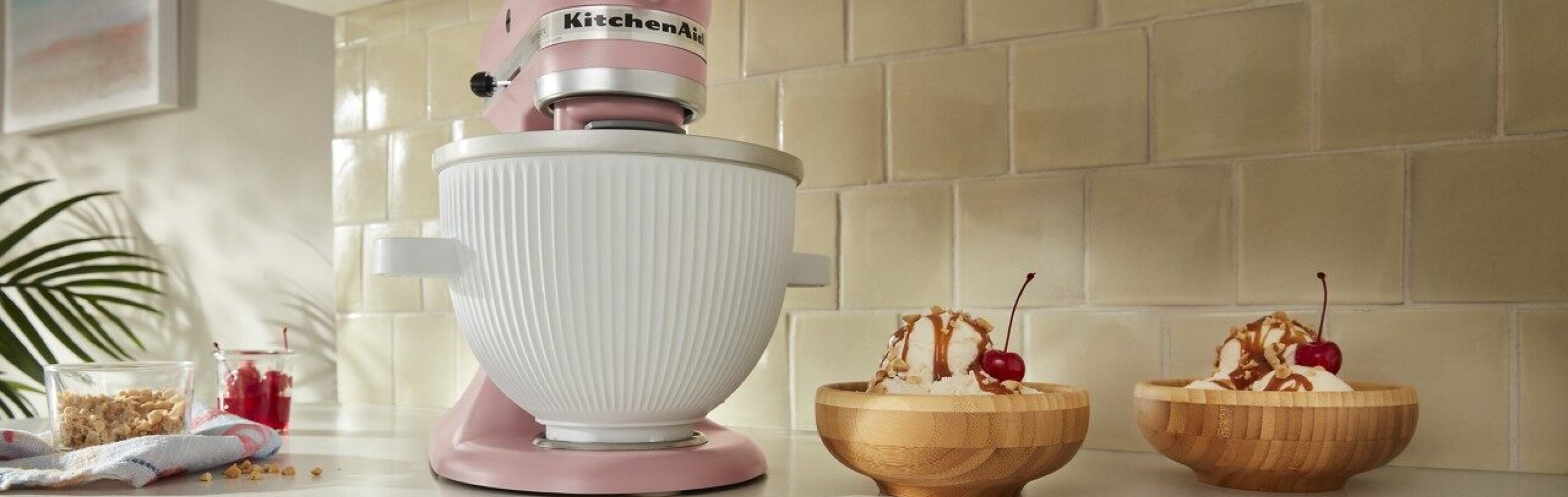 Pink KitchenAid® stand mixer next to two ice cream sundaes
