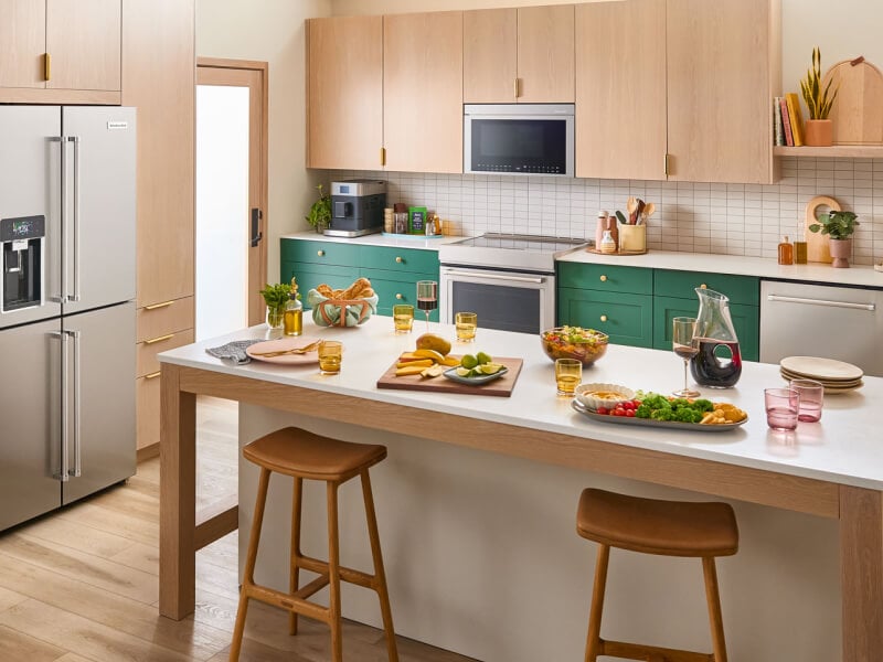 A bright kitchen island with veggie platters and wine on it A bright kitchen island with veggie platters and wine on it
