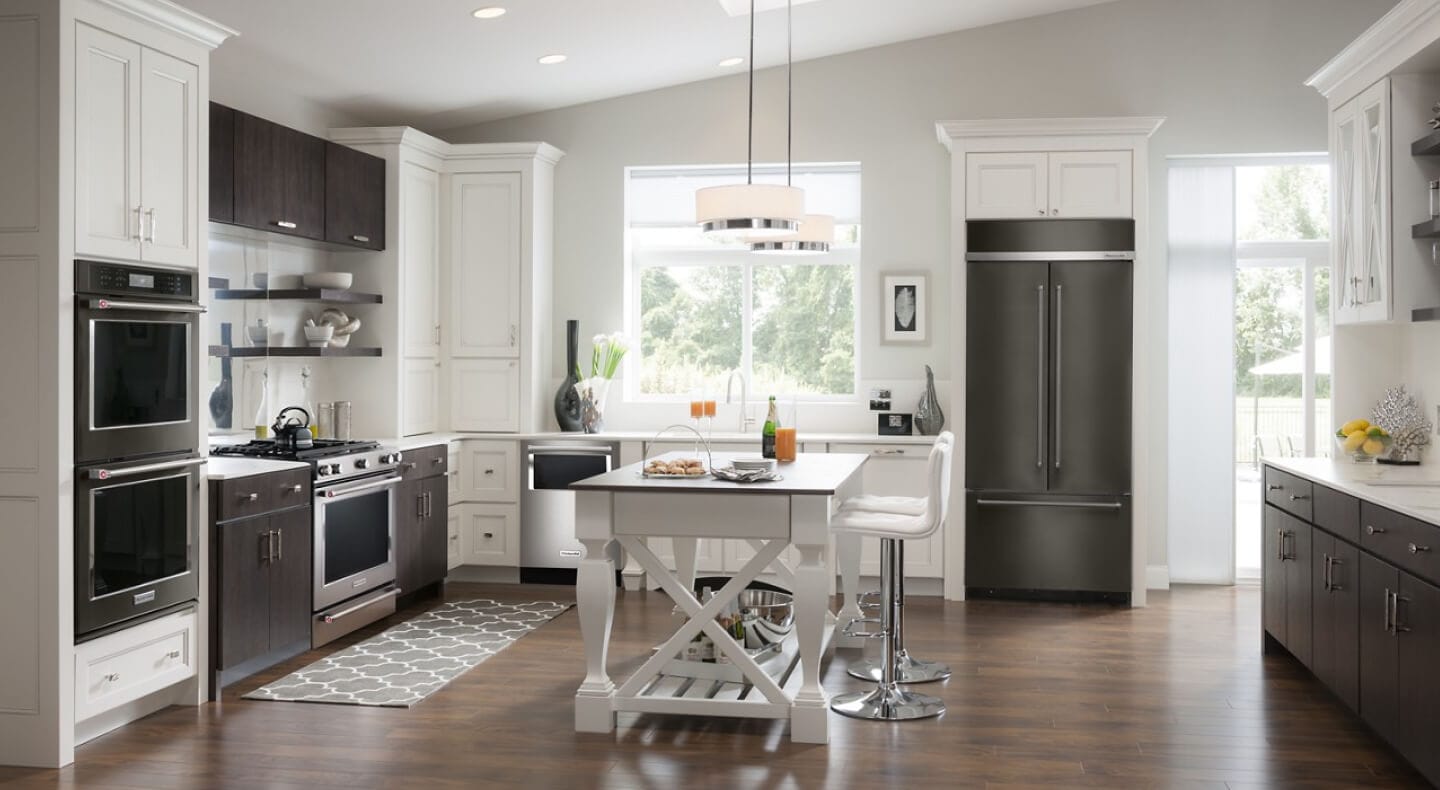 A kitchen with an island table and stool seating A kitchen with an island table and stool seating
