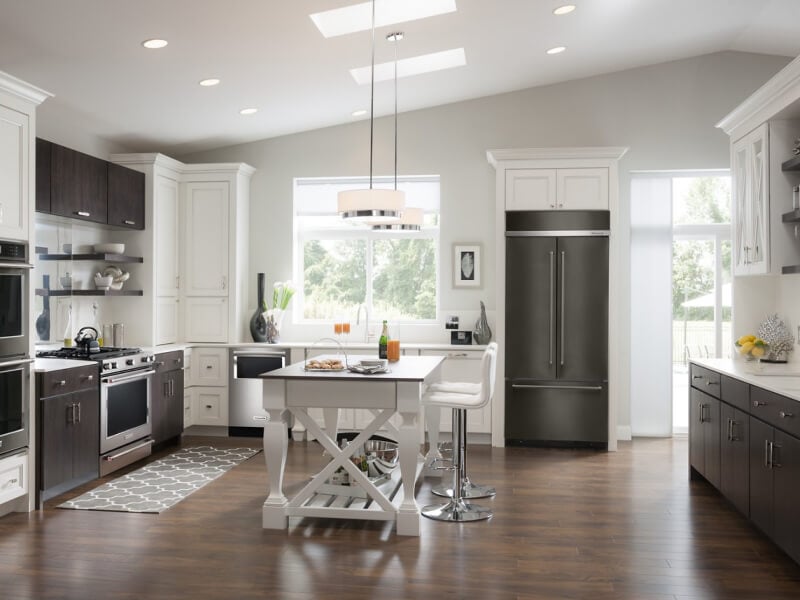 A kitchen with an island table and stool seating A kitchen with an island table and stool seating