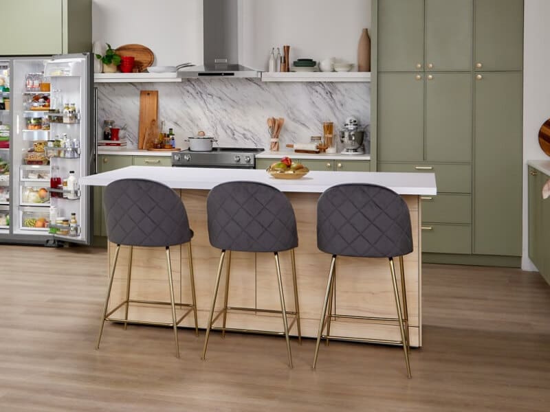 A white-topped kitchen island with three stools A white-topped kitchen island with three stools