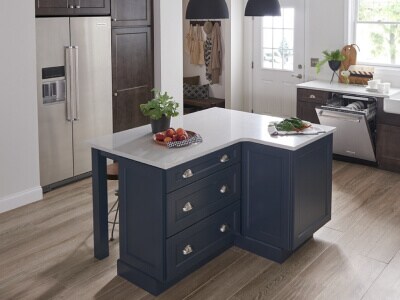 A kitchen with a large island and stainless steel appliances A kitchen with a large island and stainless steel appliances