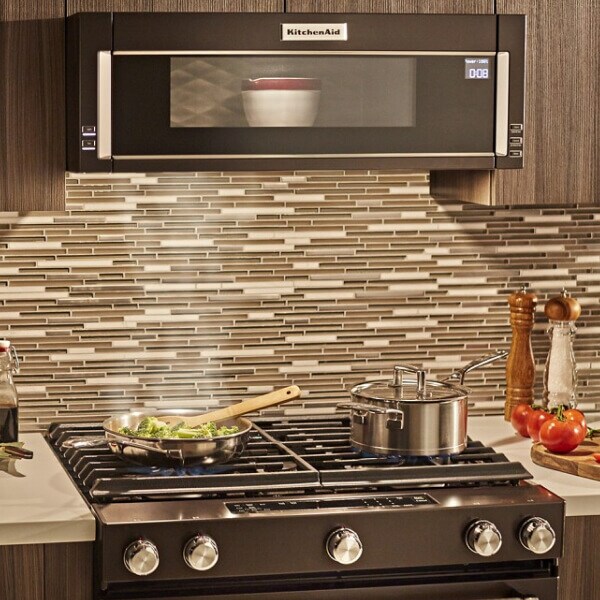 Dish heating in a black stainless, KitchenAid® low profile microwave above stovetop