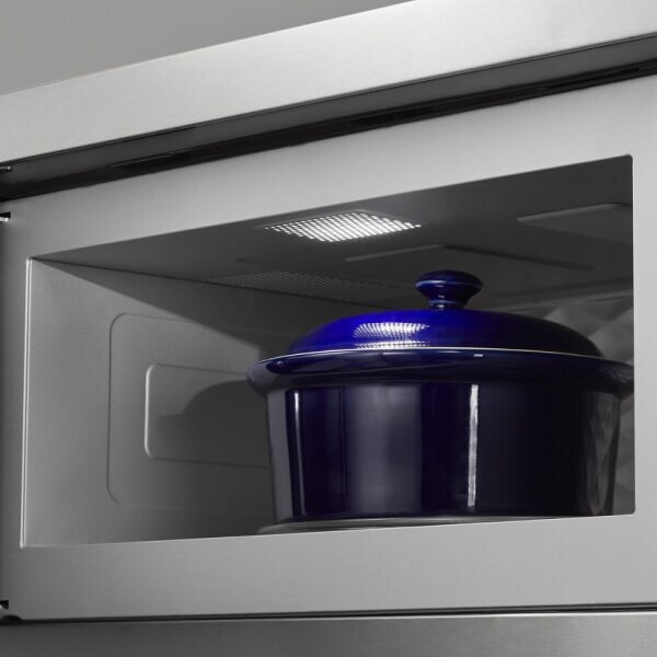 Blue ceramic pot with lid in the cavity of a low profile microwave