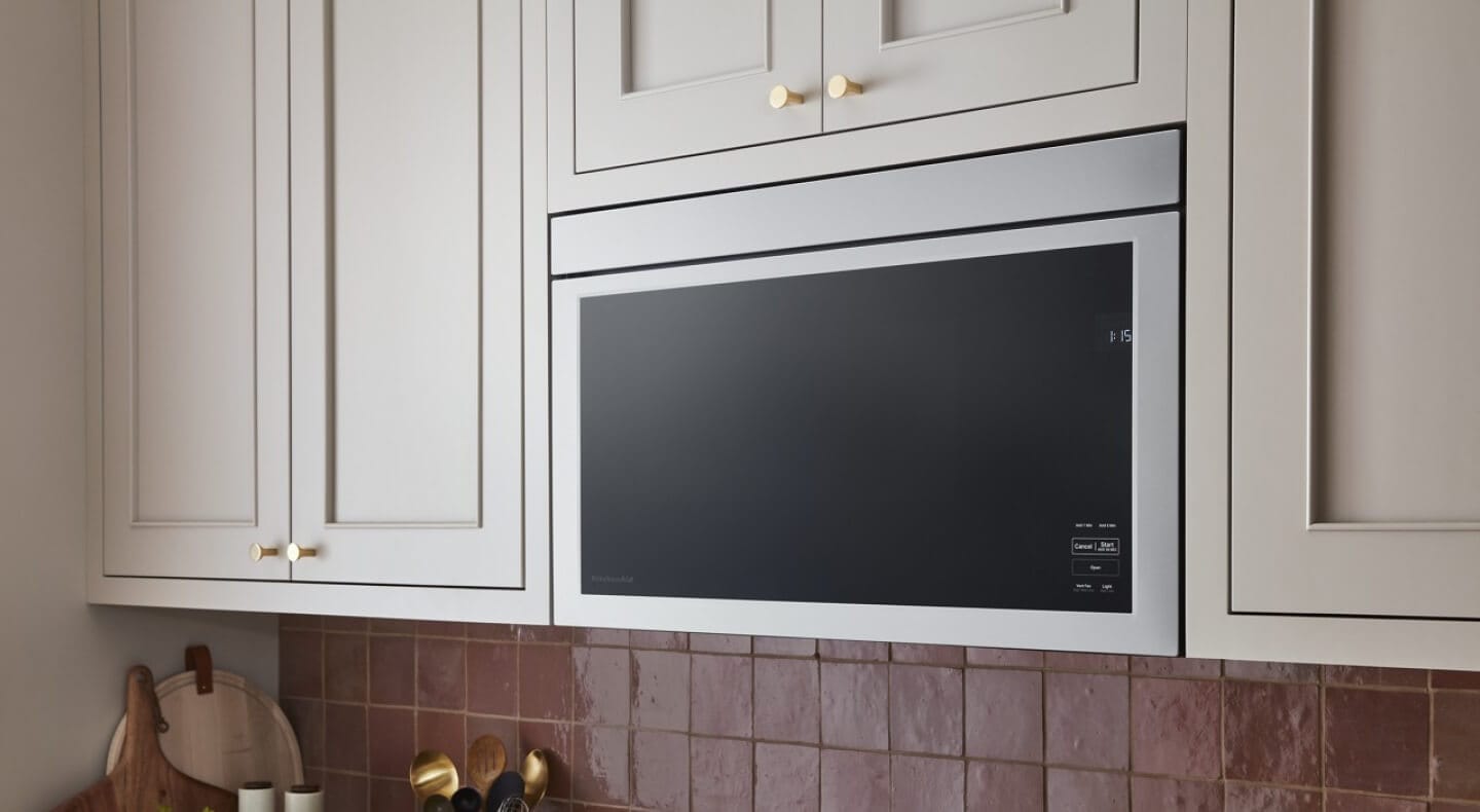 Flush over-the-range microwave against white cabinetry