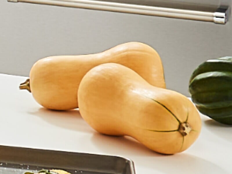 Two medium-sized butternut squashes on a counter