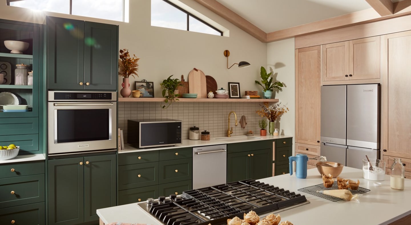 Kitchen with green cabinets and KitchenAid® appliances