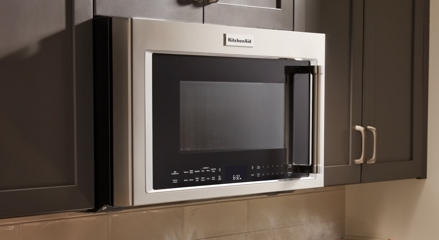 KitchenAid® over-the-range microwave in brown cabinetry KitchenAid® over-the-range microwave in brown cabinetry