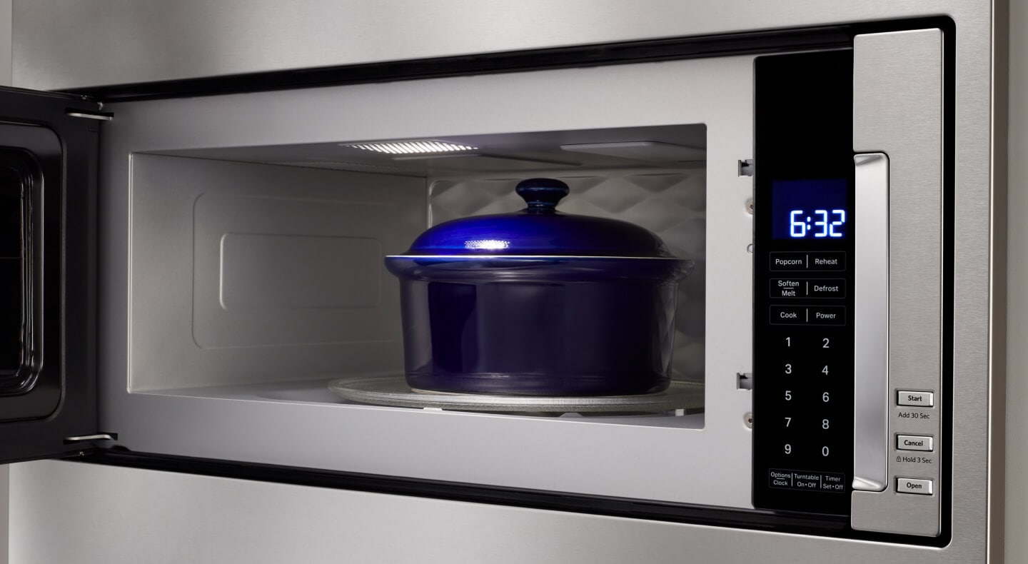 Blue dish inside microwave cavity with door open Blue dish inside microwave cavity with door open