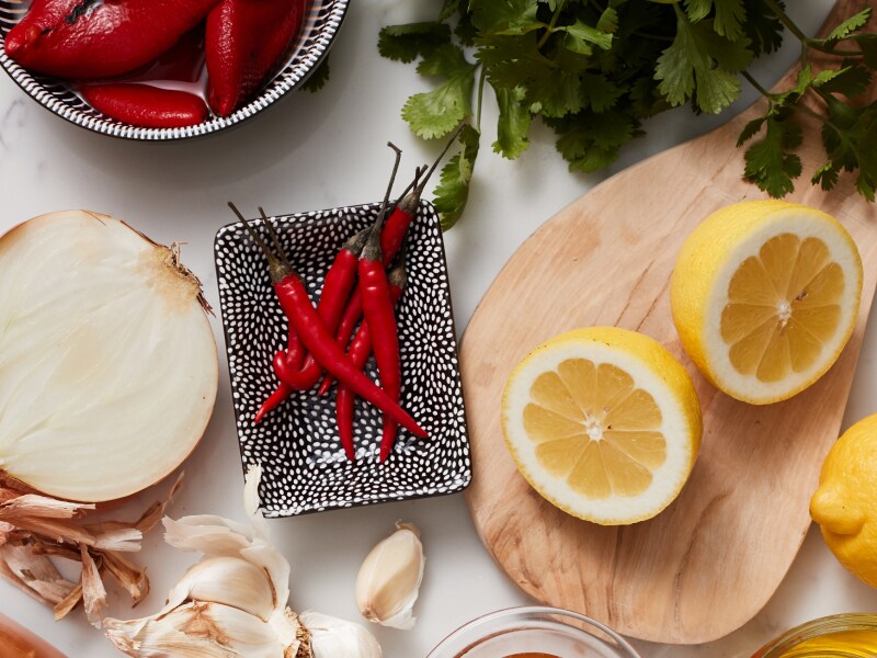 Onions, Chili peppers and lemon on table Onions, Chili peppers and lemon on table