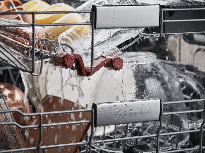 KitchenAid® wash jets washing cups and bowls in a third rack