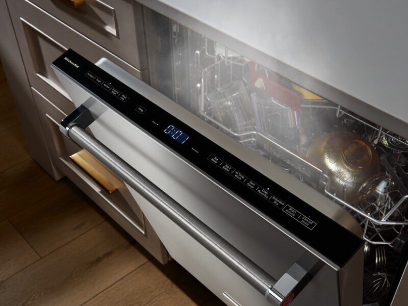 An opened KitchenAid® dishwasher letting the items inside dry