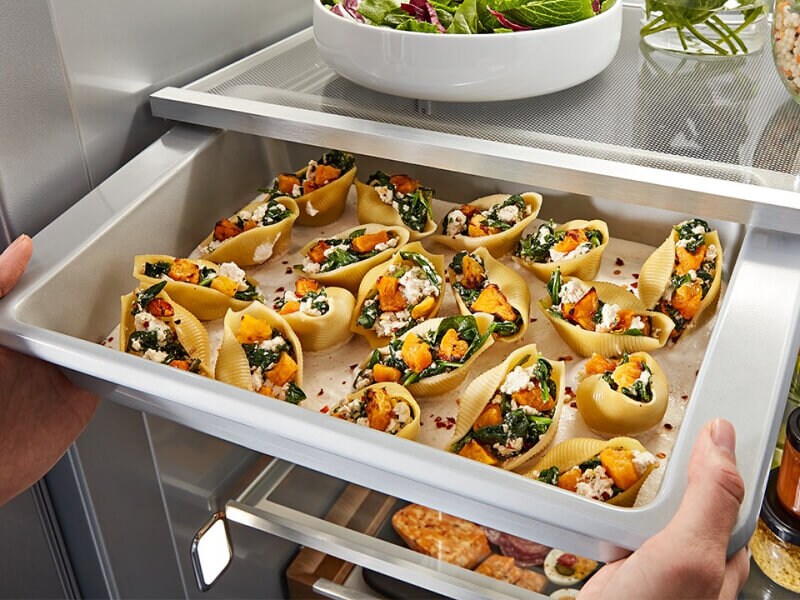 A refrigerator pull-out drawer with prepared food inside