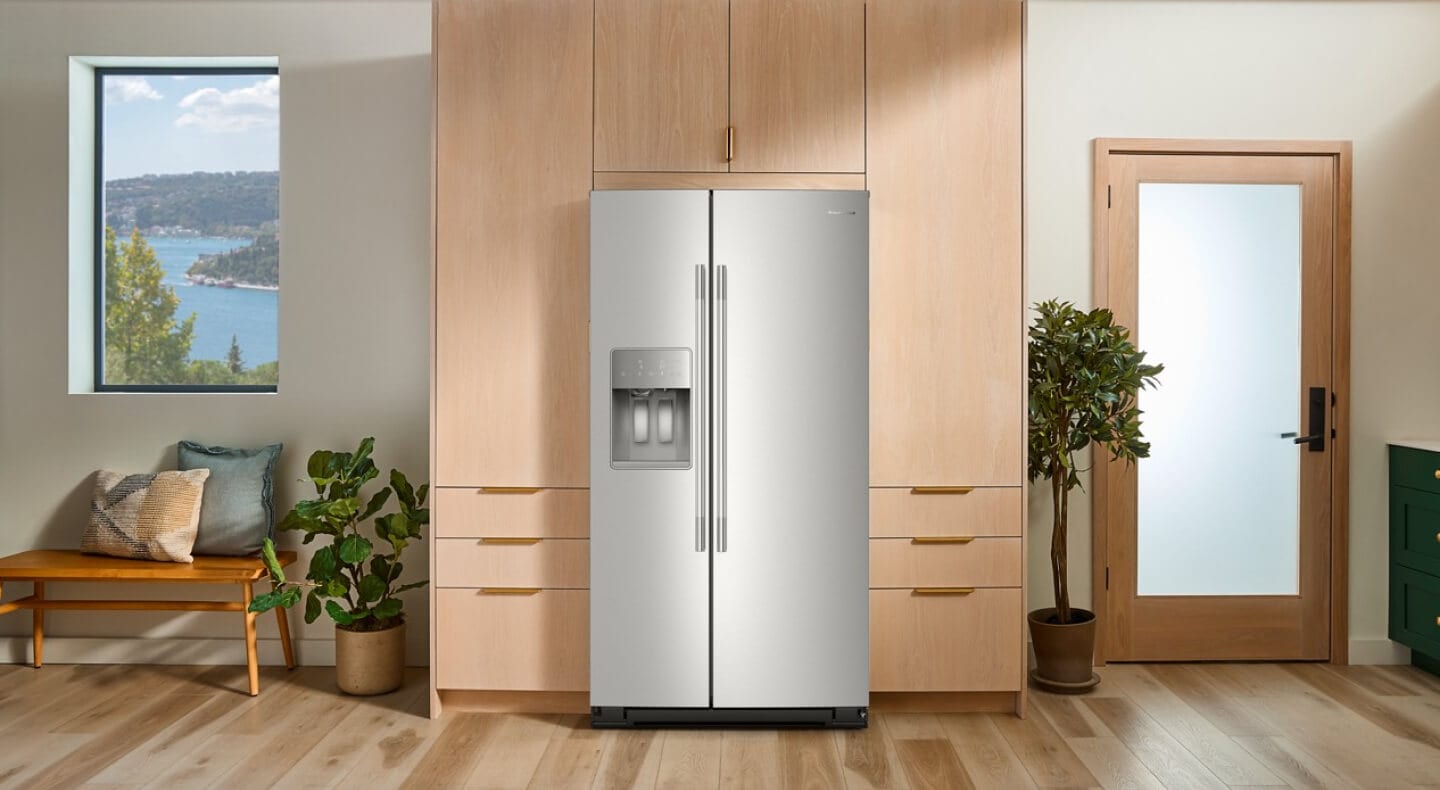 A stainless steel side-by-side refrigerator surrounded by pale wood cabinetry A stainless steel side-by-side refrigerator surrounded by pale wood cabinetry