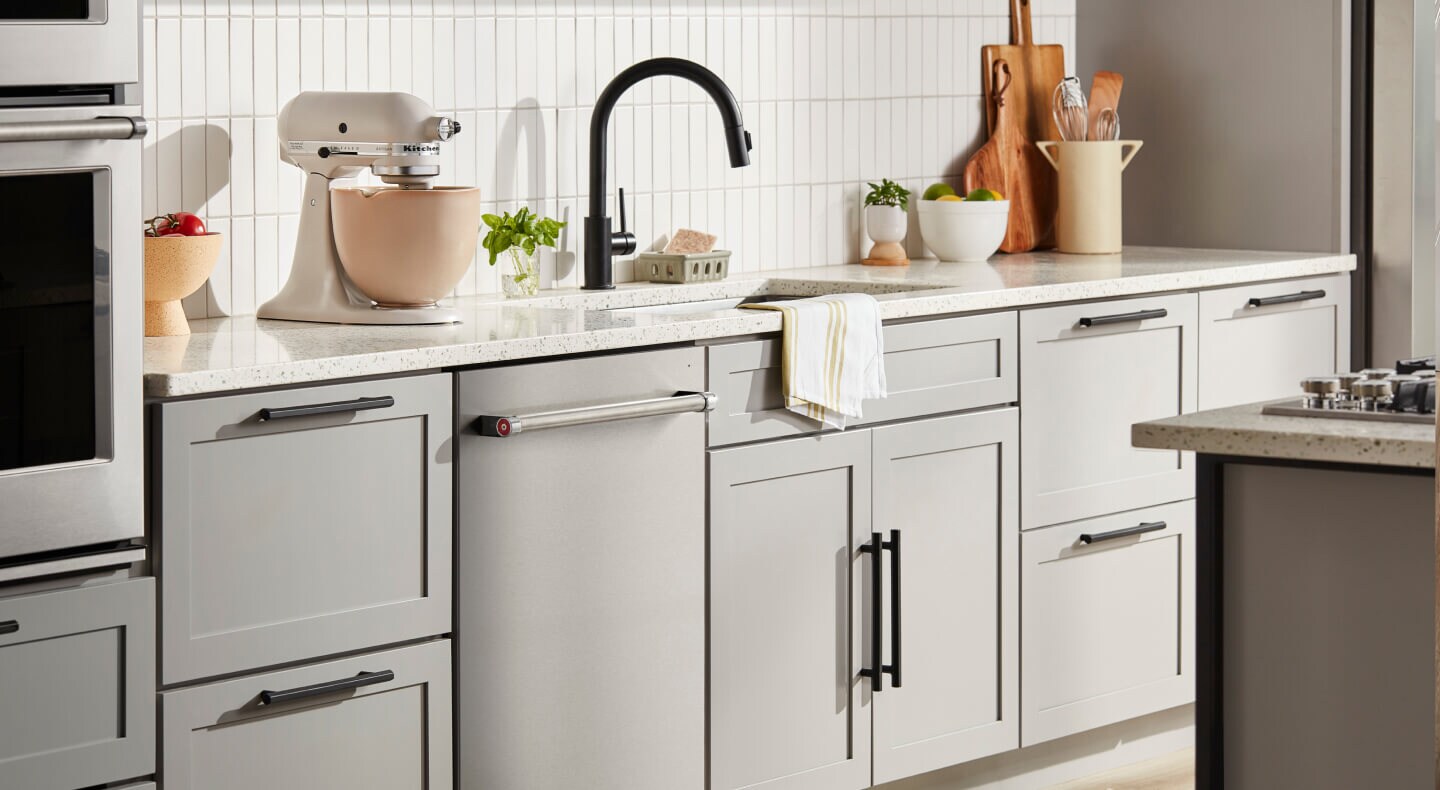KitchenAid® flush dishwasher among light gray kitchen cabinetry KitchenAid® flush dishwasher among light gray kitchen cabinetry