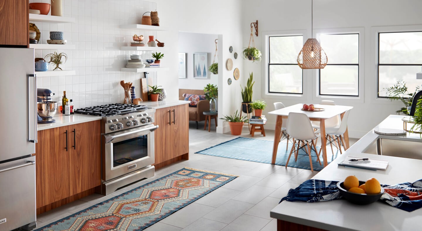 Open kitchen with a commercial-style gas range by KitchenAid brand Open kitchen with a commercial-style gas range by KitchenAid brand