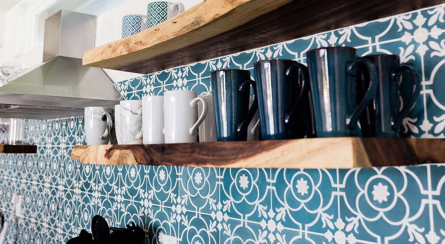 Mugs on floating wood shelves installed on a patterned wall Mugs on floating wood shelves installed on a patterned wall