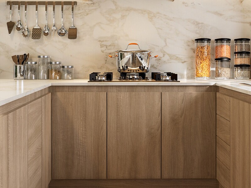 Light brown cabinetry with no handles on cabinets or drawers Light brown cabinetry with no handles on cabinets or drawers