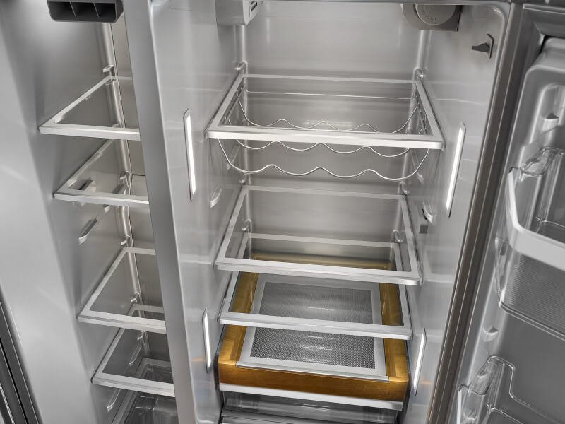 Empty KitchenAid® side-by-side refrigerator with a wine rack Empty KitchenAid® side-by-side refrigerator with a wine rack