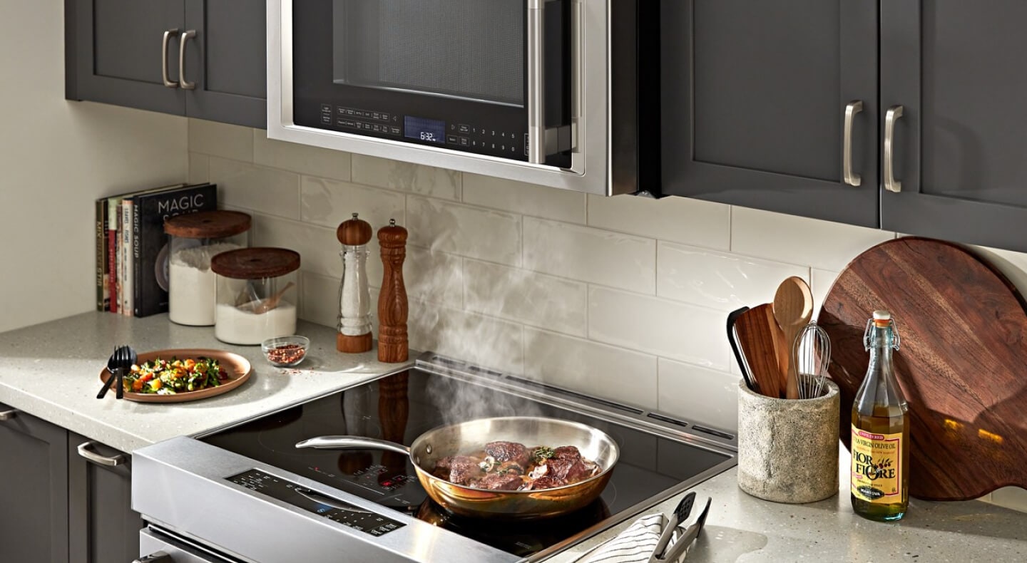 A KitchenAid® range and microwave in a small kitchen
