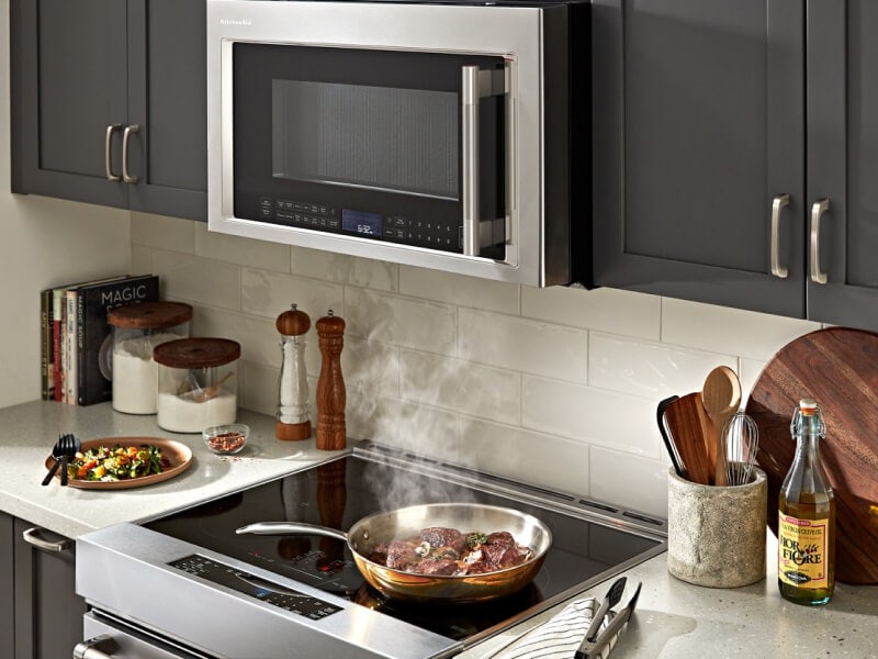 A KitchenAid® range and microwave in a small kitchen