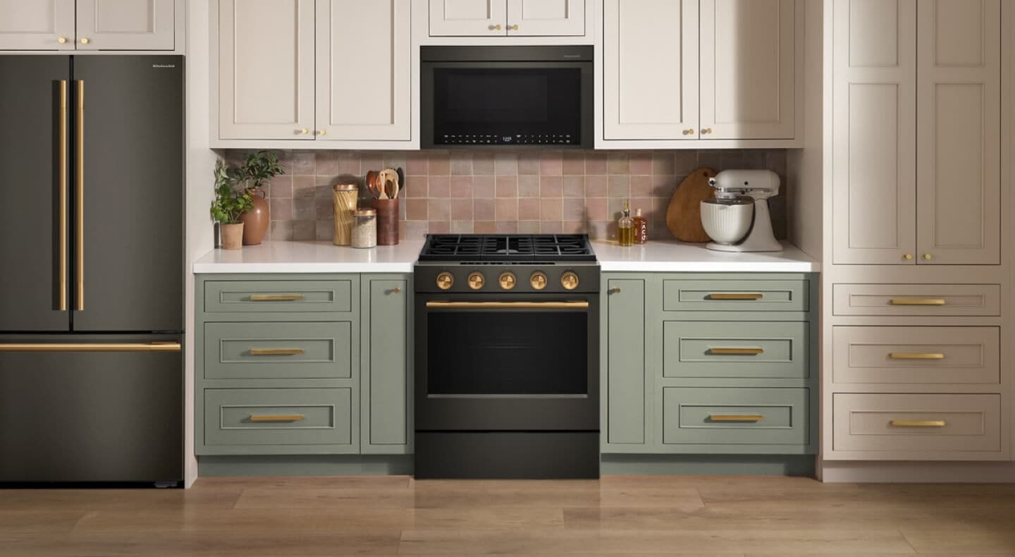 A KitchenAid® range, microwave and refrigerator in Black Ore
