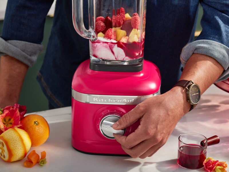 Hand adjusting speed on KitchenAid® blender