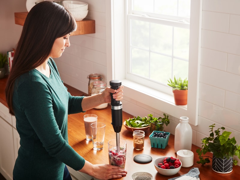 Person blending berry smoothie withKitchenAid® hand blender