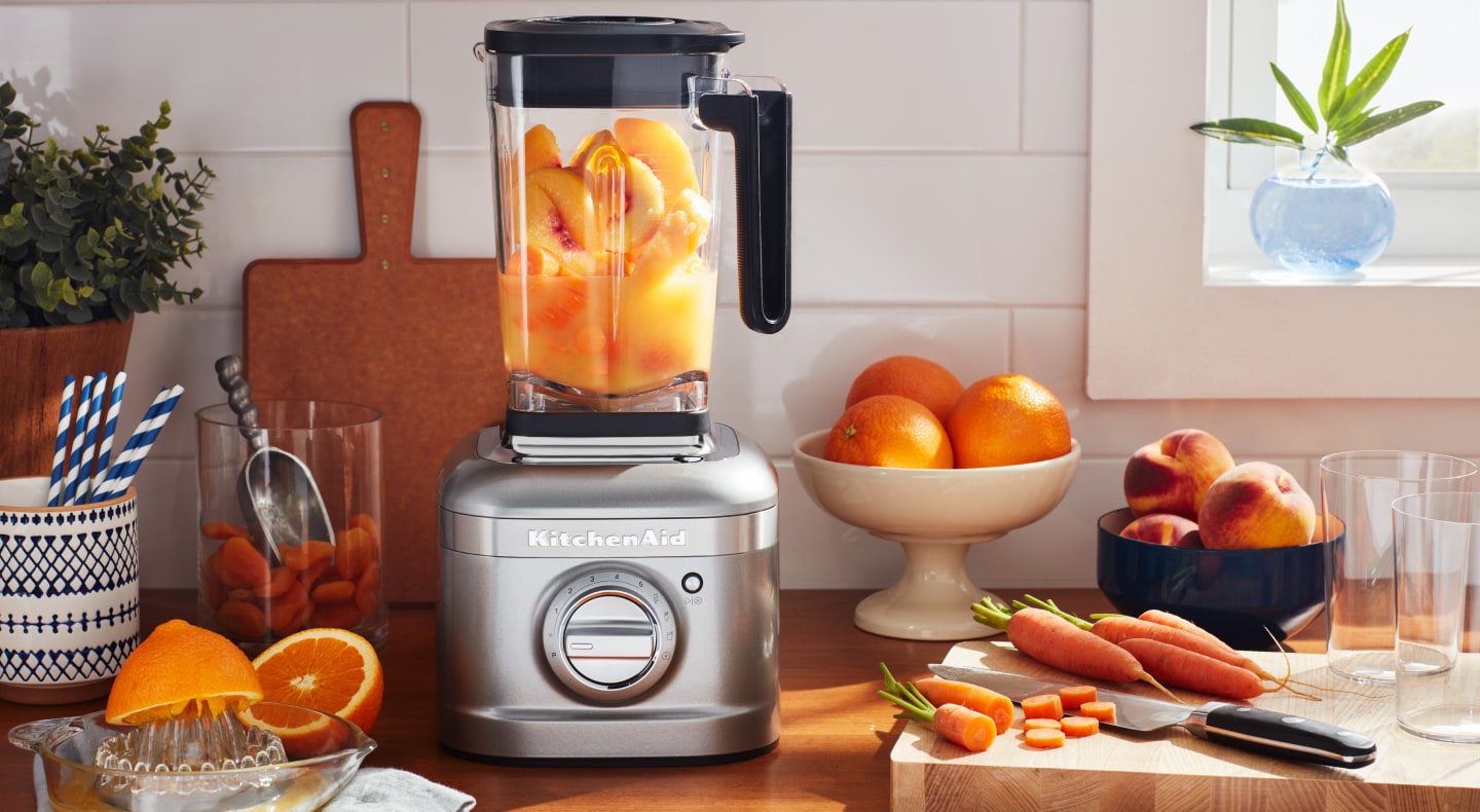 KitchenAid® blender with oranges fruits and carrots on countertop KitchenAid® blender with oranges fruits and carrots on countertop
