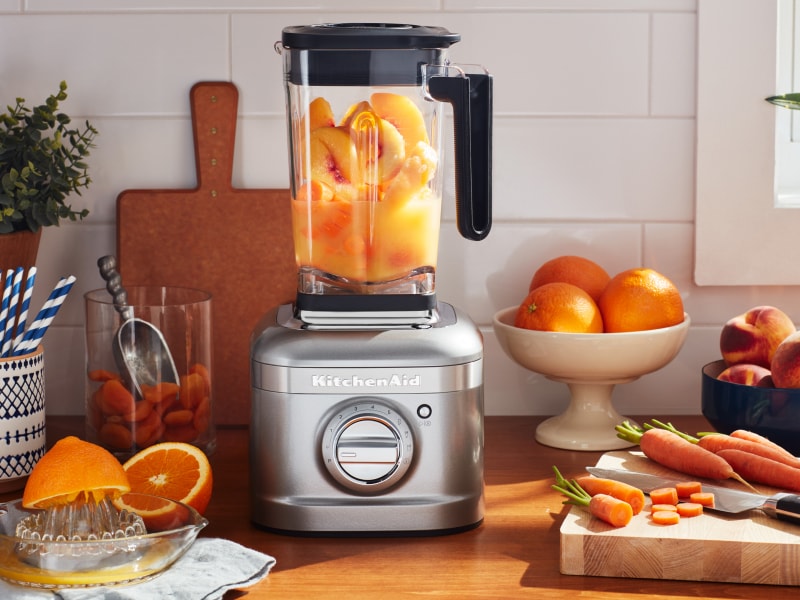 KitchenAid® blender with oranges fruits and carrots on countertop KitchenAid® blender with oranges fruits and carrots on countertop
